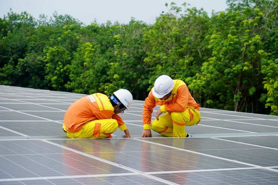 Solar panel installation team working on a residential roof